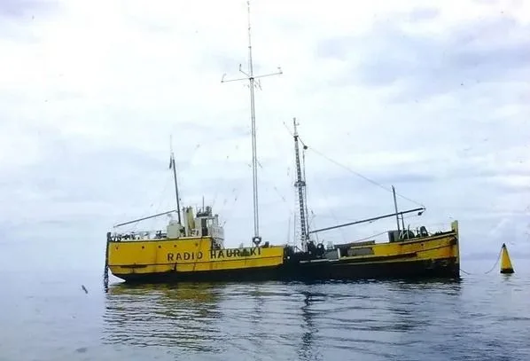 MV Tiri — the Radio Hauraki pirate radio ship, painted yellow and moored in the Colville Channel off Great Barrier Island.