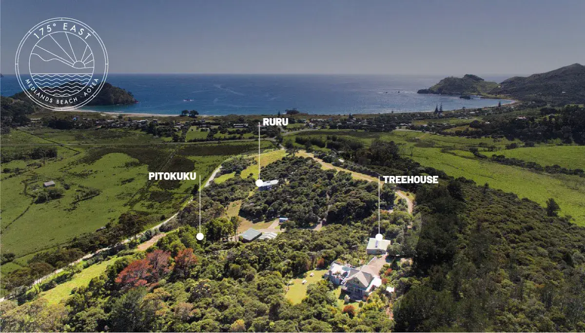 Aerial view of 175° East accommodation above Medlands Beach, Aotea Great Barrier Island